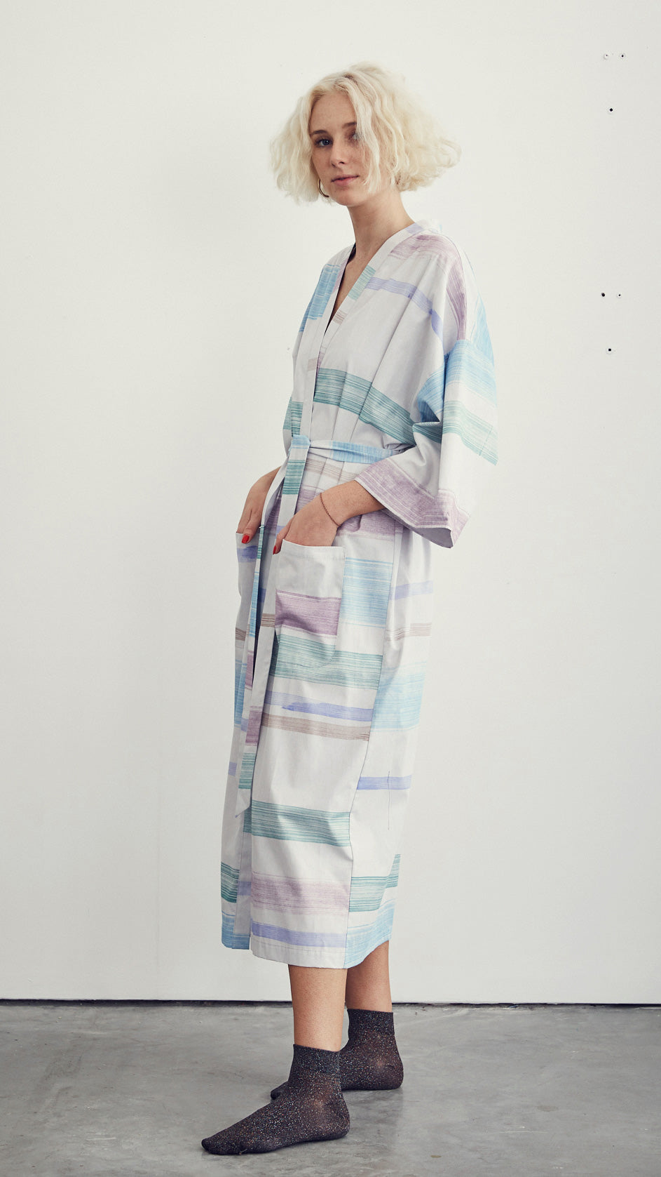 cardinal gift shop mid-weight cotton robe in stripe pattern on a woman